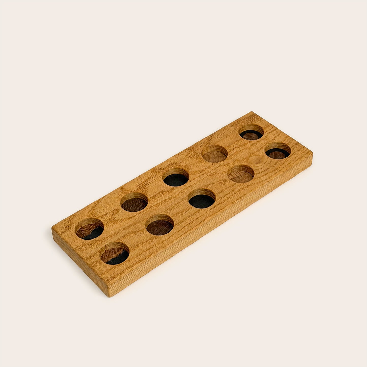 Play & Hang in Natural Oak with Mono Palette, showing the wooden pegboard with holes for the matching play figures.