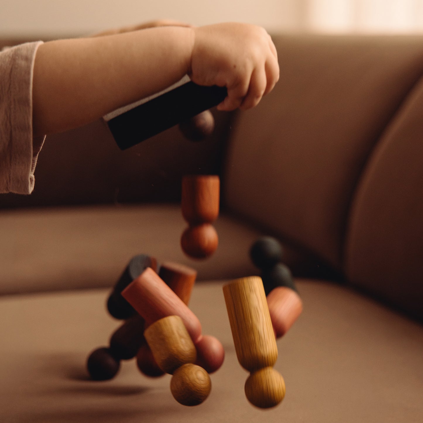 Child playing with wooden Play & Hang pieces by Woodsie Wonder, representing the digital gift card.