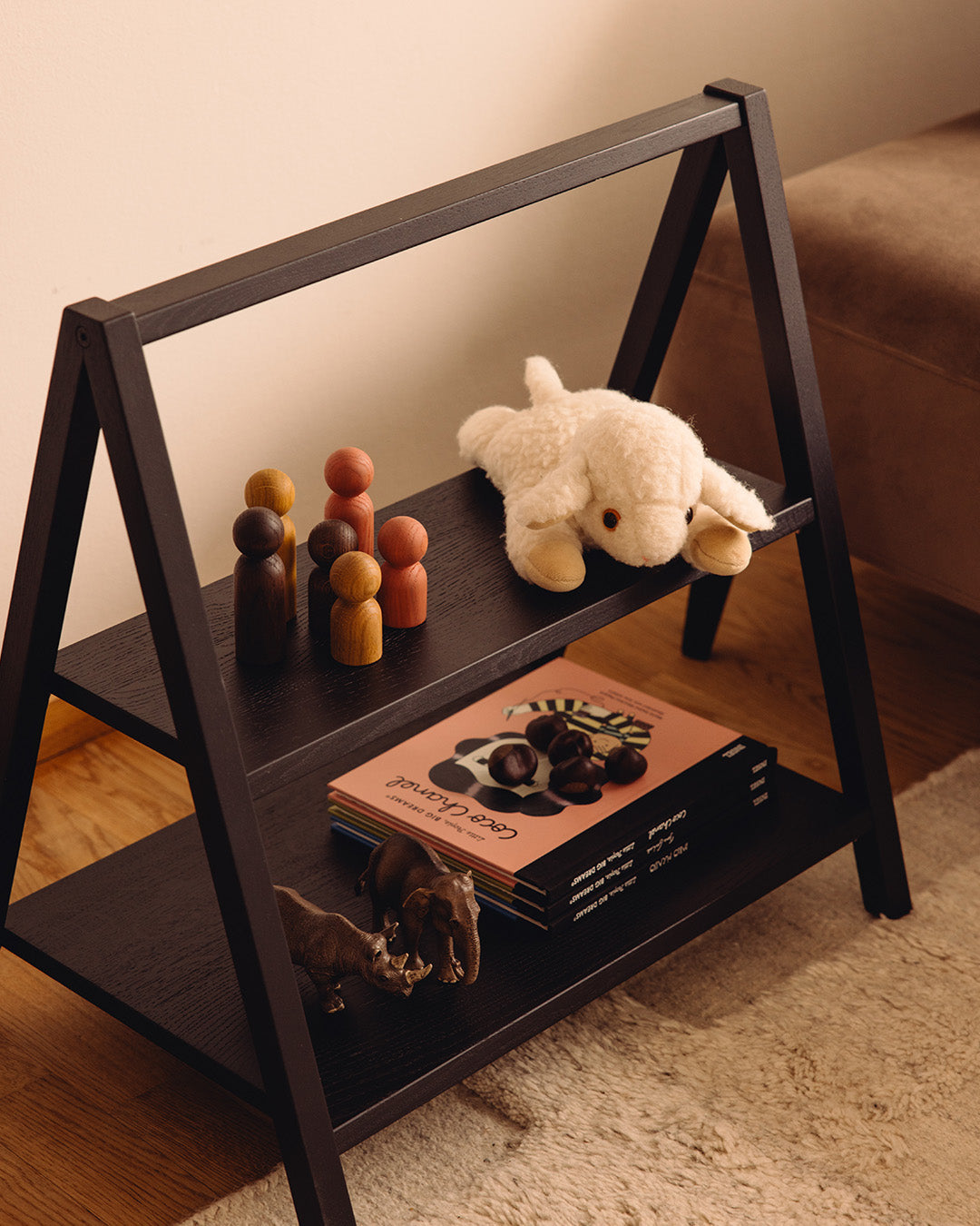 Play & Read by Woodsie Wonder transformed into a Black Oak bookshelf, styled in a modern living room.