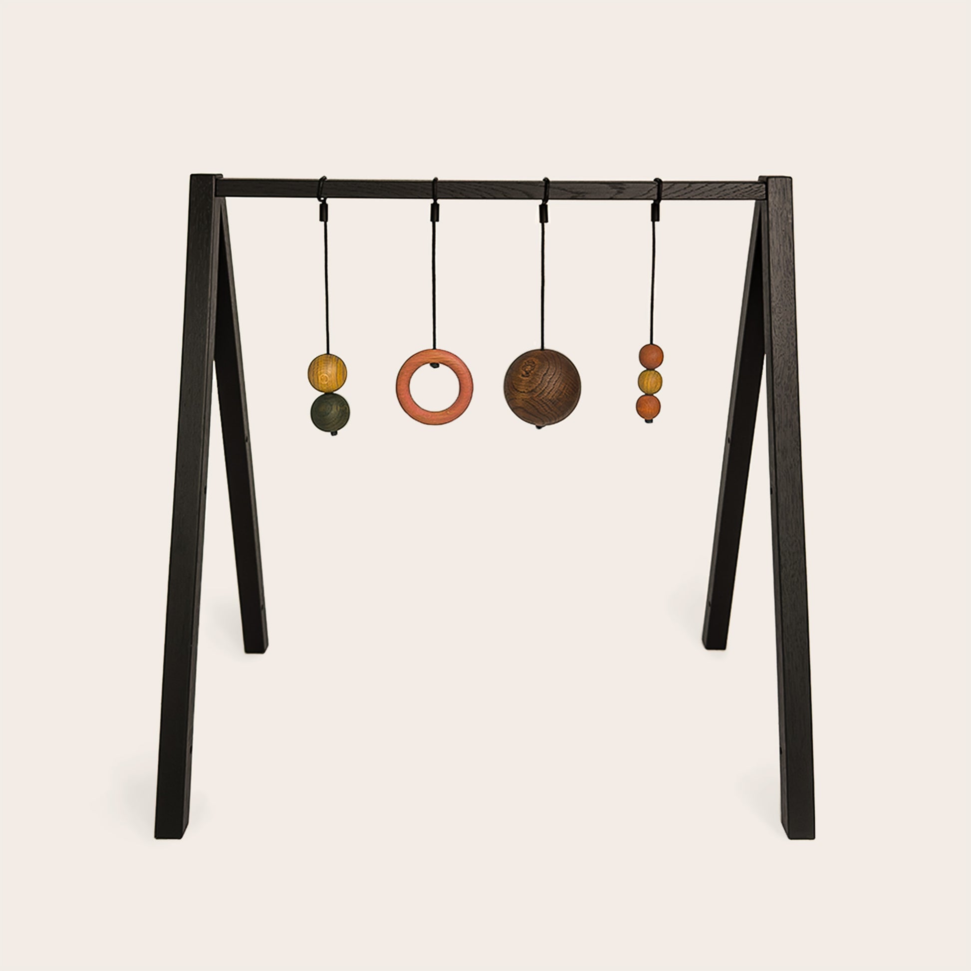 Wooden baby gym that transforms into a children's bookshelf. Play & Read in Black Oak with Earth Palette by Woodsie Wonder.