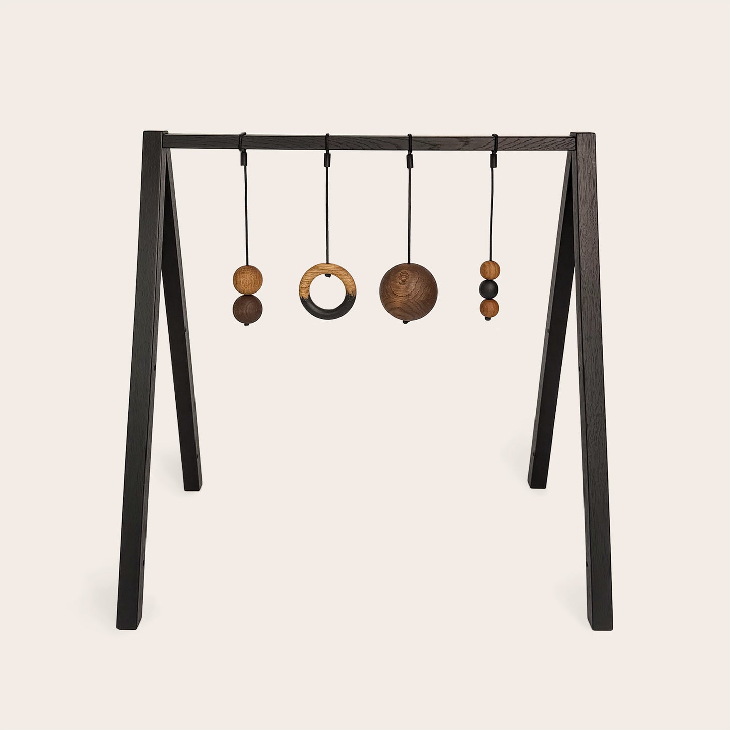 Wooden baby gym that transforms into a children's bookshelf. Play & Read in Black Oak with Mono Palette by Woodsie Wonder.