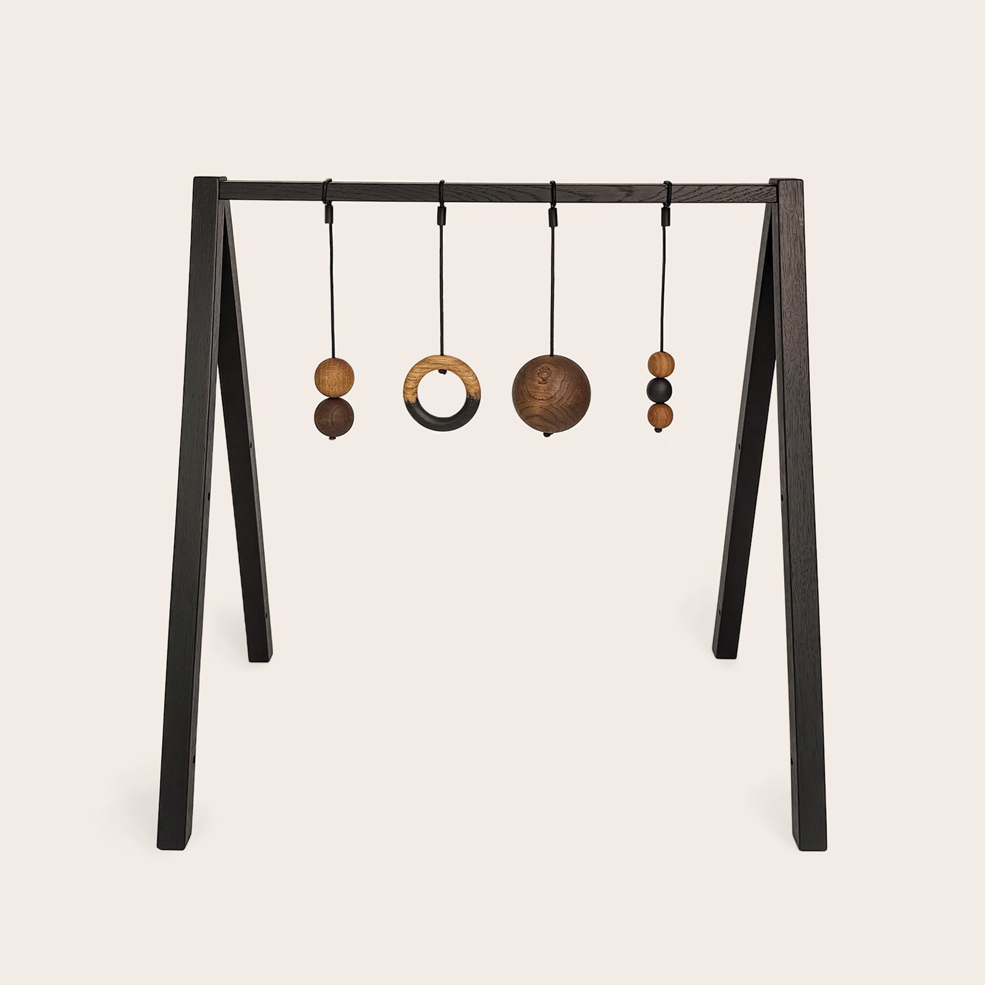 Wooden baby gym that transforms into a children's bookshelf. Play & Read in Black Oak with Mono Palette by Woodsie Wonder.