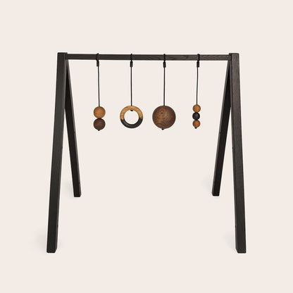 Wooden baby gym that transforms into a children's bookshelf. Play & Read in Black Oak with Mono Palette by Woodsie Wonder.