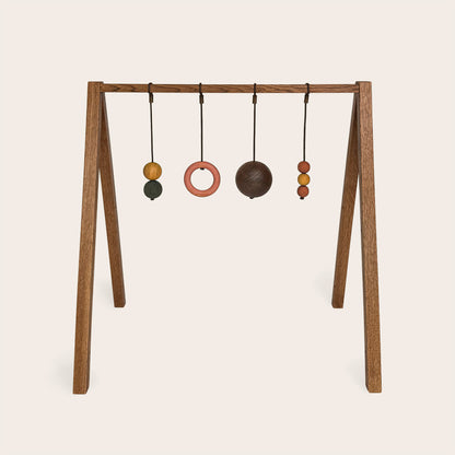 Wooden baby gym that transforms into a children's bookshelf. Play & Read in Brown Oak with Earth Palette by Woodsie Wonder.