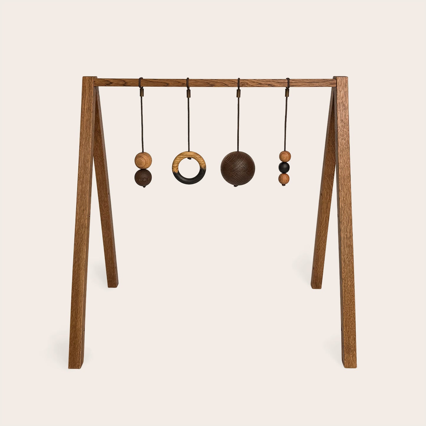 Wooden baby gym that transforms into a children's bookshelf. Play & Read in Brown Oak with Mono Palette by Woodsie Wonder.
