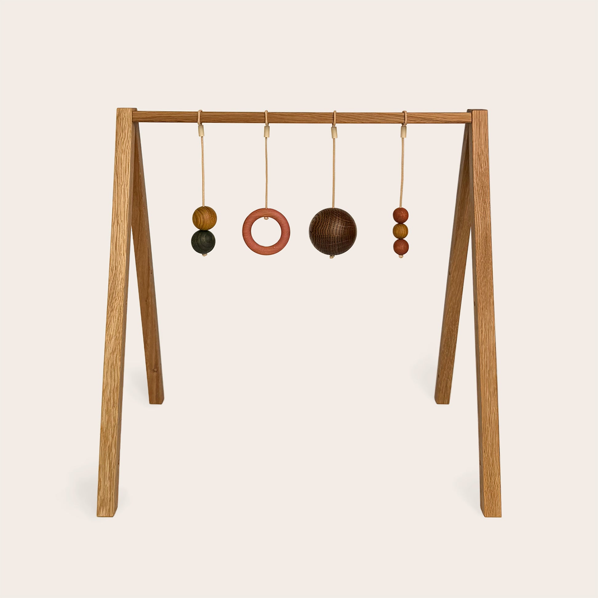 Wooden baby gym that transforms into a children's bookshelf. Play & Read in Natural Oak with Earth Palette by Woodsie Wonder.