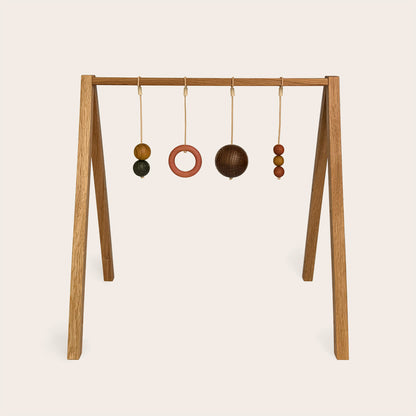 Wooden baby gym that transforms into a children's bookshelf. Play & Read in Natural Oak with Earth Palette by Woodsie Wonder.