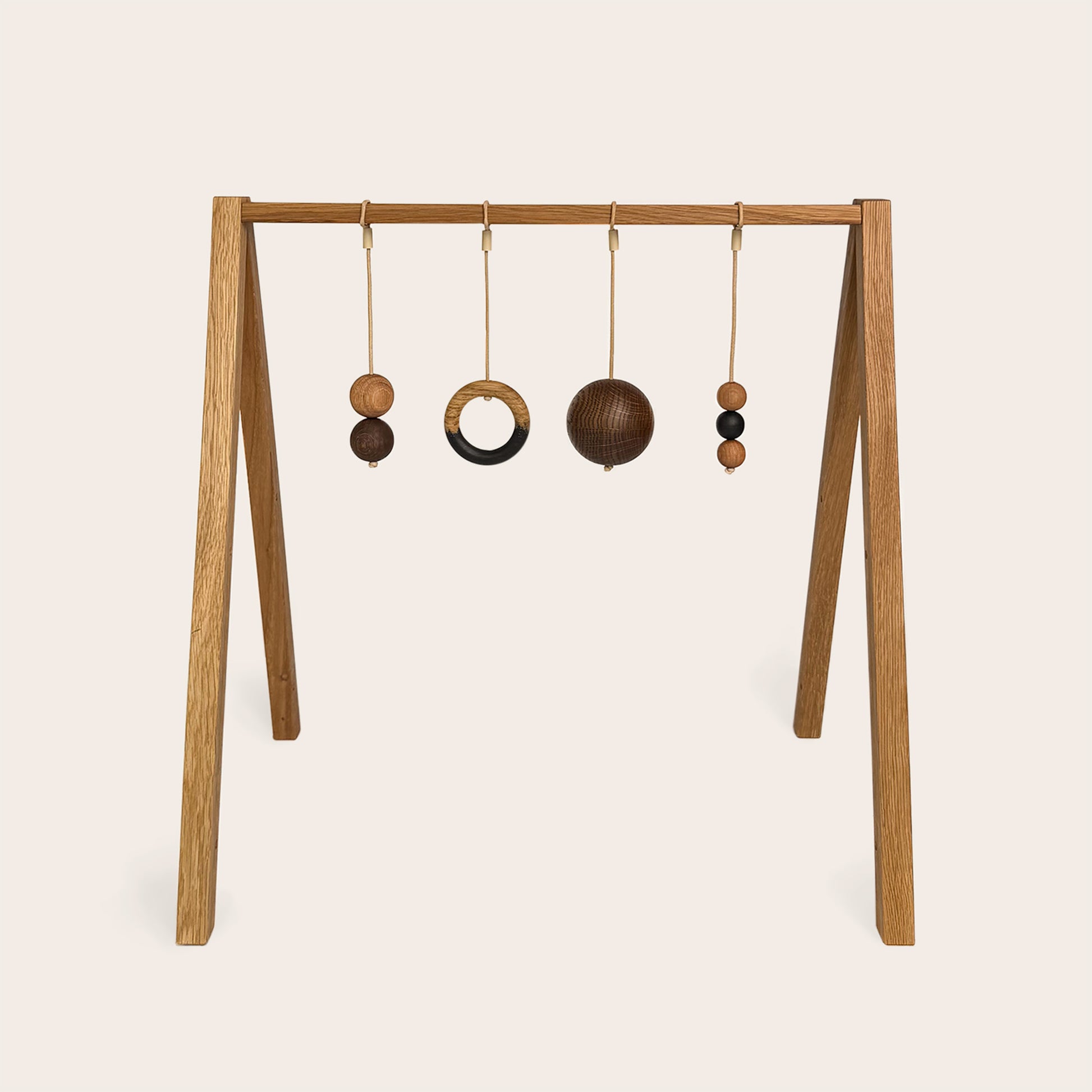 Wooden baby gym that transforms into a children's bookshelf. Play & Read in Natural Oak with Mono Palette by Woodsie Wonder.