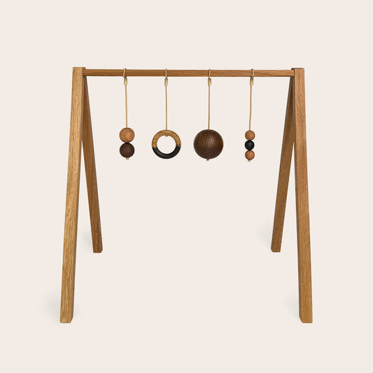 Wooden baby gym that transforms into a children's bookshelf. Play & Read in Natural Oak with Mono Palette by Woodsie Wonder.