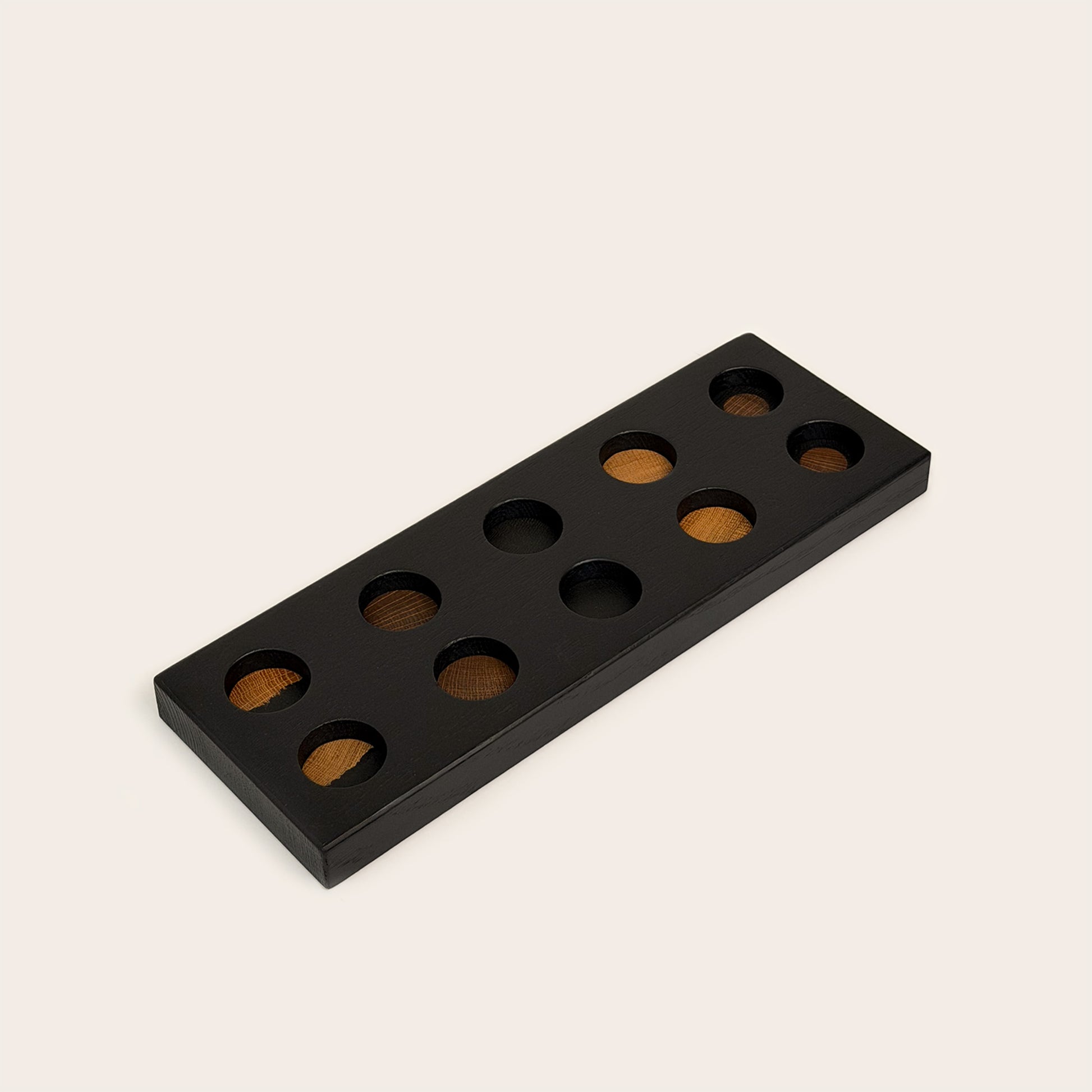 Play & Hang in Black Oak with Mono Palette, showing the wooden pegboard with holes for the matching play figures.