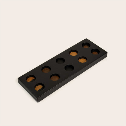 Play & Hang in Black Oak with Mono Palette, showing the wooden pegboard with holes for the matching play figures.