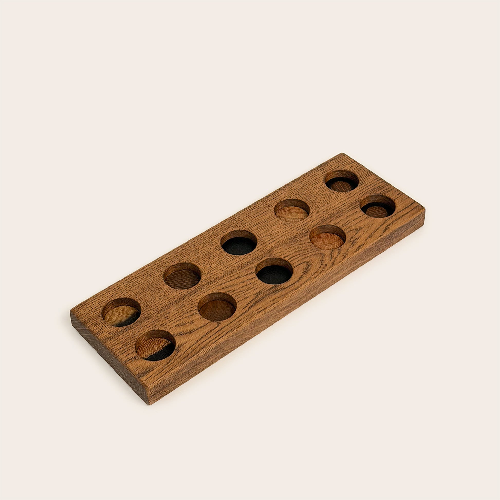 Play & Hang in Brown Oak with Mono Palette, showing the wooden pegboard with holes for the matching play figures.