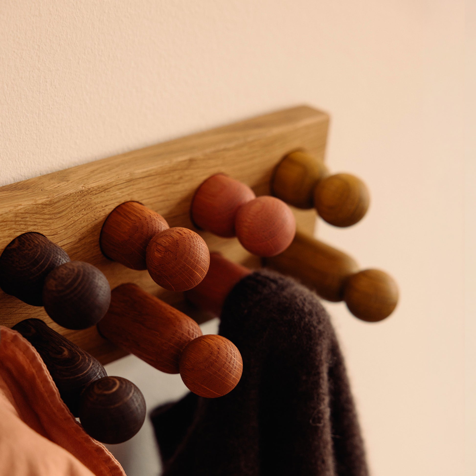 Wooden kids wall hooks in Natural Oak with Earth Palette, shown in close-up detail as part of the Play & Hang coat rack by Woodsie Wonder.