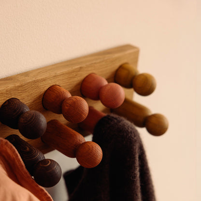 Wooden kids wall hooks in Natural Oak with Earth Palette, shown in close-up detail as part of the Play & Hang coat rack by Woodsie Wonder.
