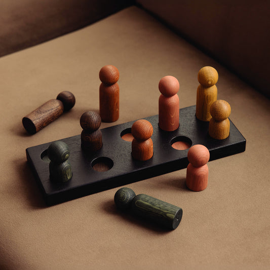 Wooden pegboard sorting toy by Woodsie Wonder in Black Oak with Earth Palette, designed for colour matching, fine motor play and later use as a children’s coat rack.