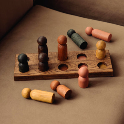Wooden pegboard sorting toy by Woodsie Wonder in Brown Oak with Earth Palette, designed for colour matching, fine motor play and later use as a children’s coat rack.
