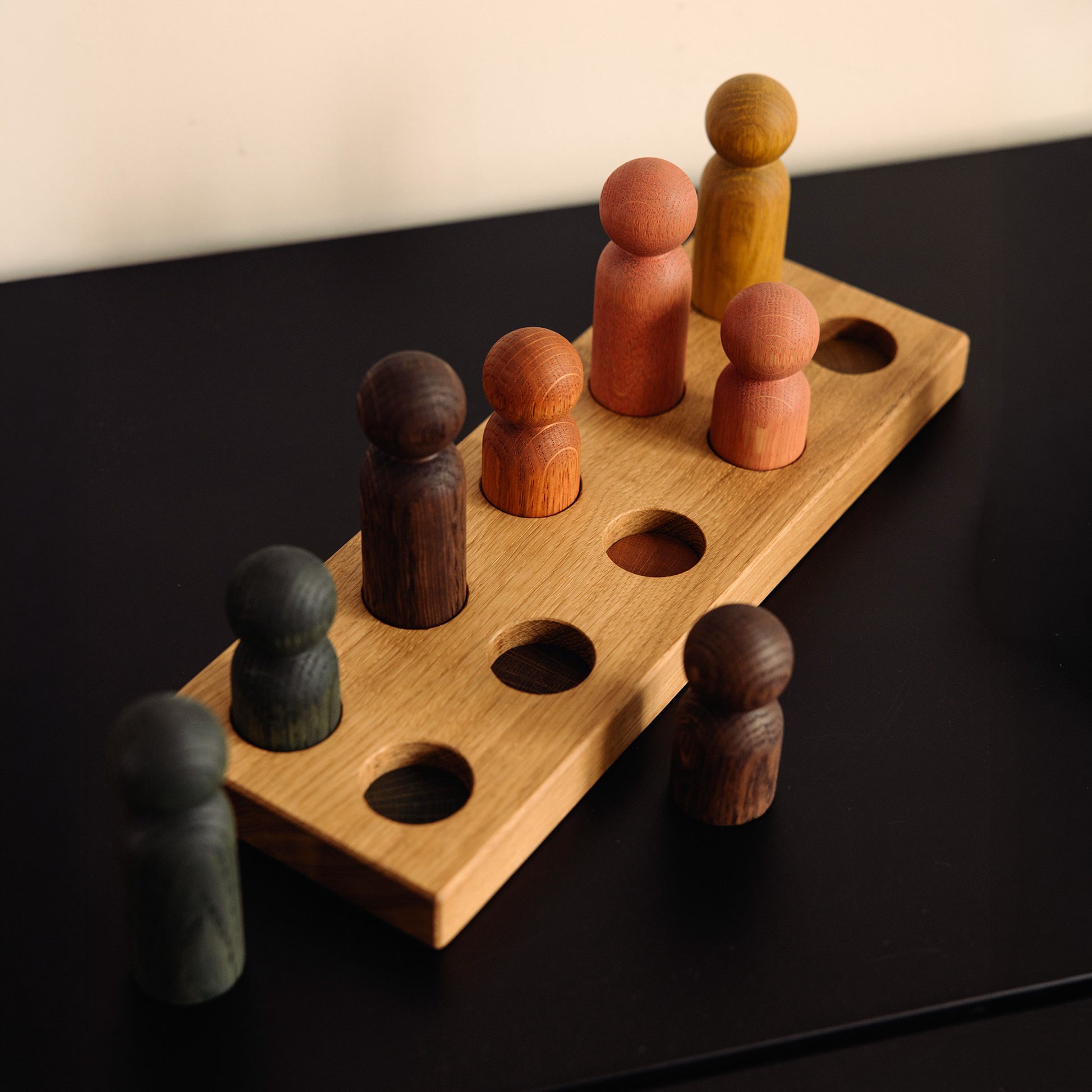 Wooden pegboard sorting toy by Woodsie Wonder in Natural Oak with Earth Palette, designed for colour matching, fine motor play and later use as a children’s coat rack.