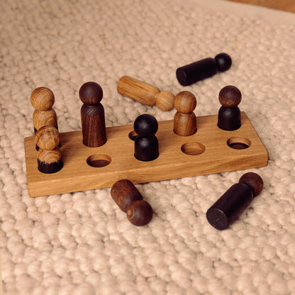 Wooden pegboard sorting toy by Woodsie Wonder in Natural Oak with Mono Palette, designed for colour matching, fine motor play and later use as a children’s coat rack.