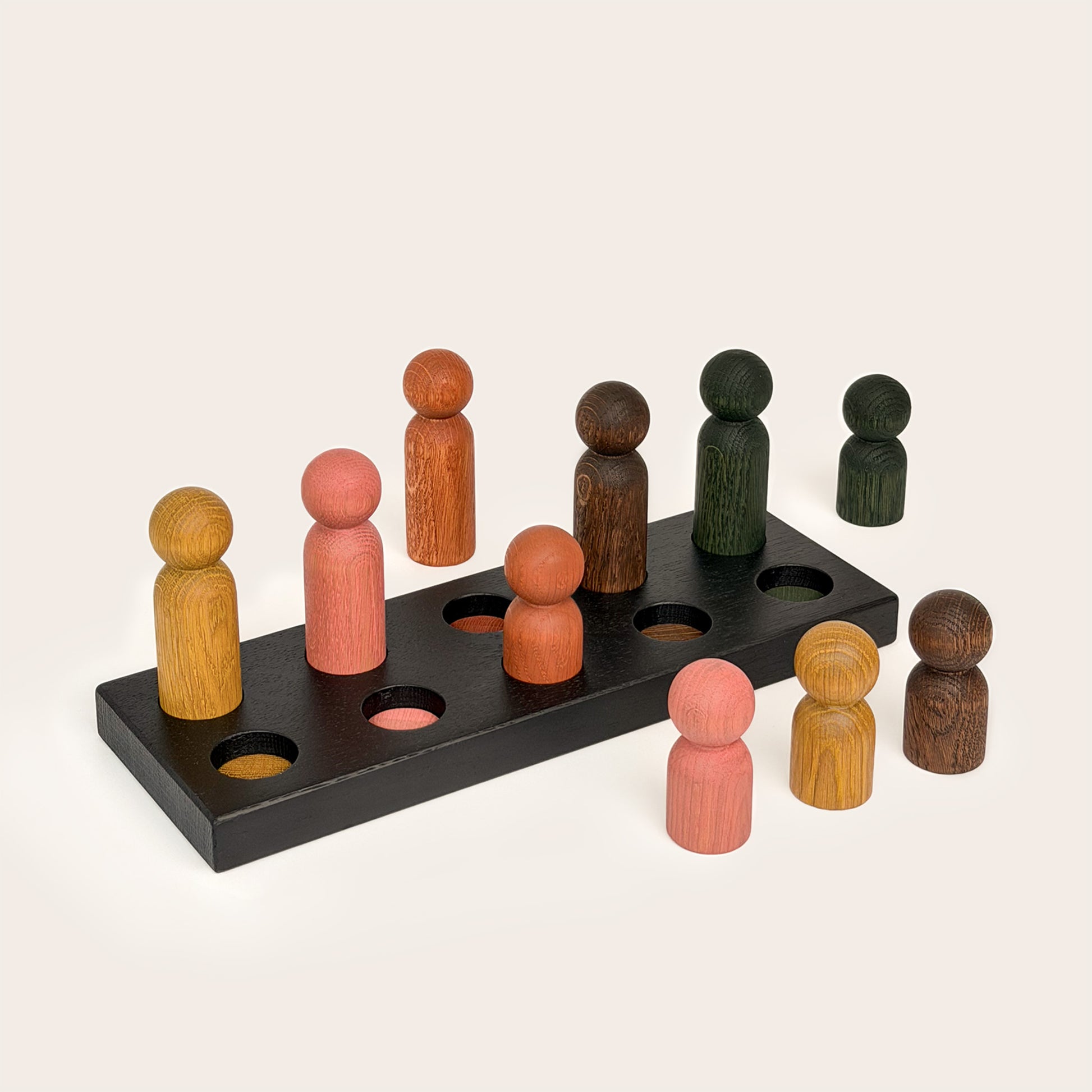 Play & Hang in Black Oak with Earth Palette, a wooden sorting toy with colour-matching pegs that transforms into a children's coat rack by Woodsie Wonder.