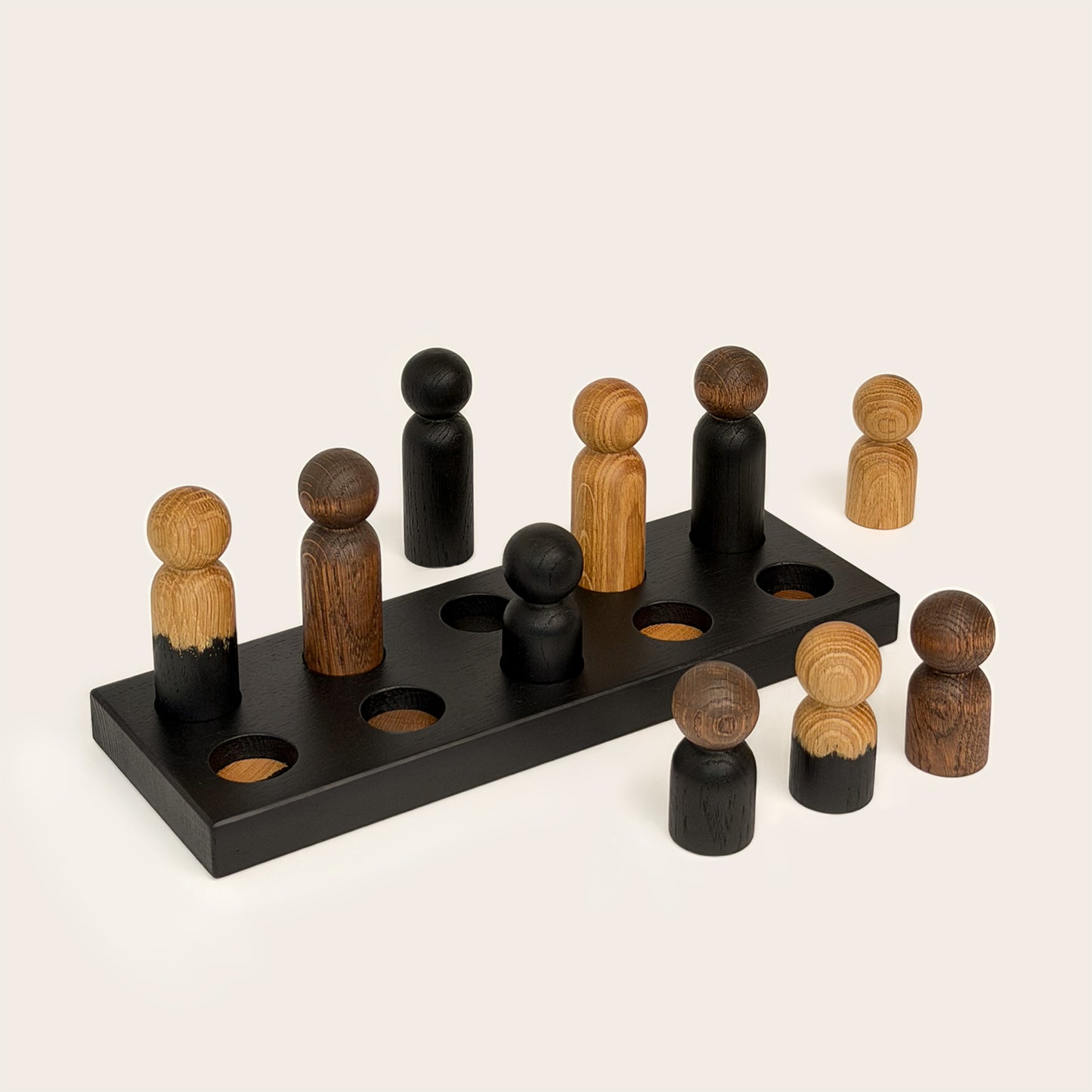 Play & Hang in Black Oak with Mono Palette, a wooden sorting toy with colour-matching pegs that transforms into a children's coat rack by Woodsie Wonder.