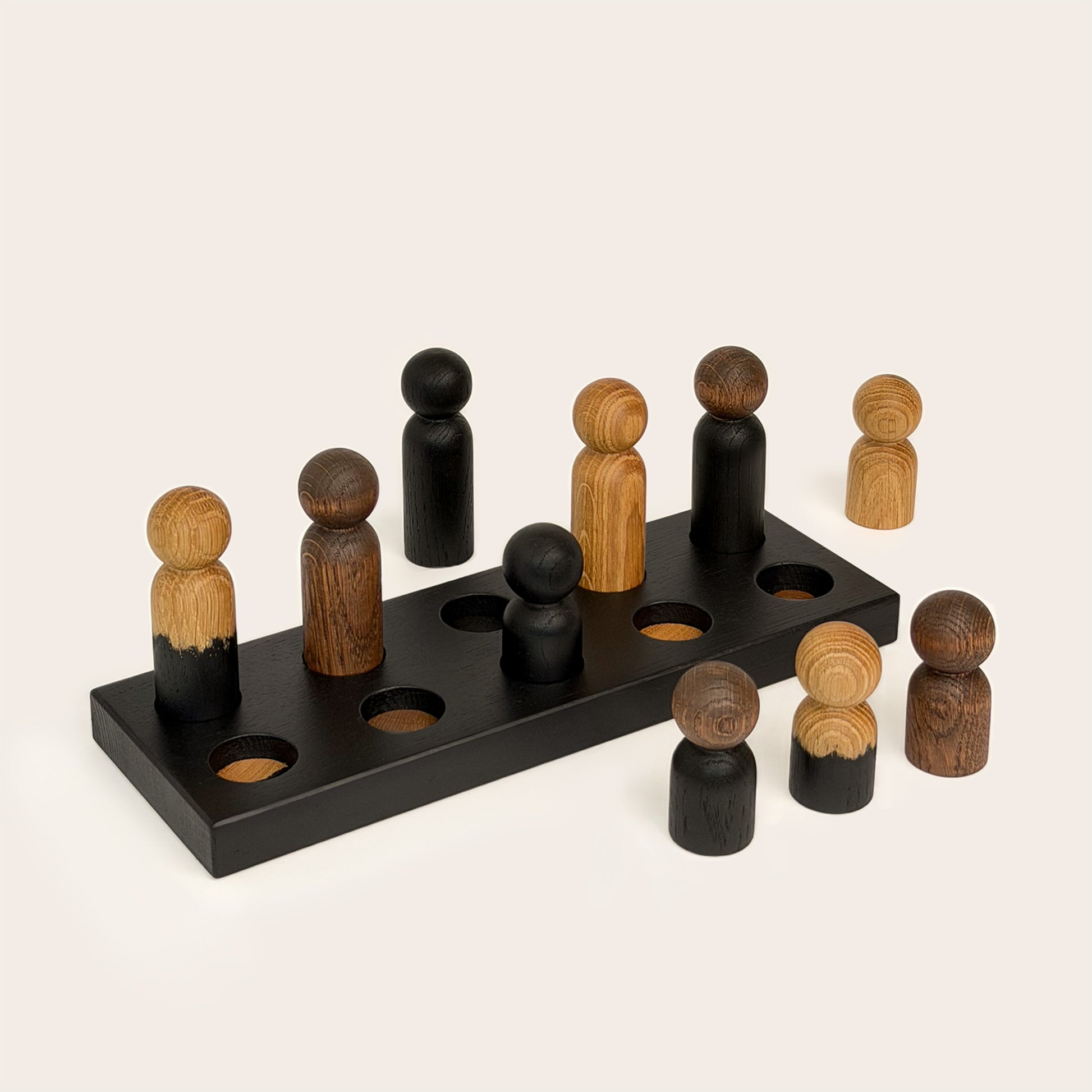 Play & Hang in Black Oak with Mono Palette, a wooden sorting toy with colour-matching pegs that transforms into a children's coat rack by Woodsie Wonder.