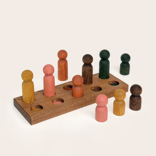 Play & Hang in Brown Oak with Earth Palette, a wooden sorting toy with colour-matching pegs that transforms into a children's coat rack by Woodsie Wonder.