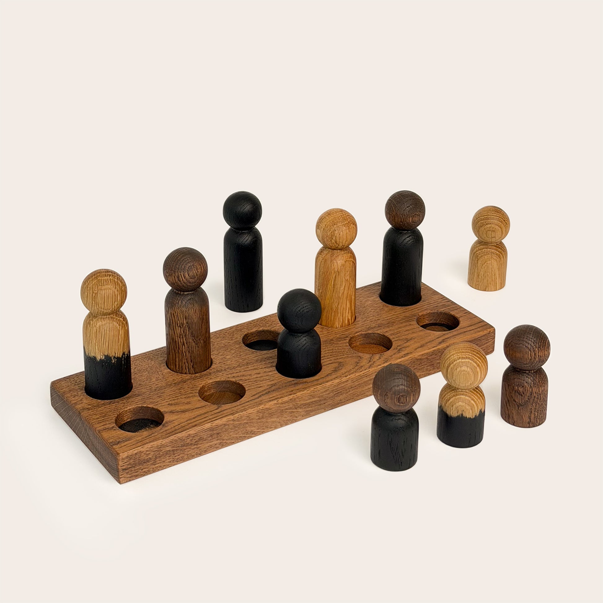 Play & Hang in Brown Oak with Mono Palette, a wooden sorting toy with colour-matching pegs that transforms into a children's coat rack by Woodsie Wonder.