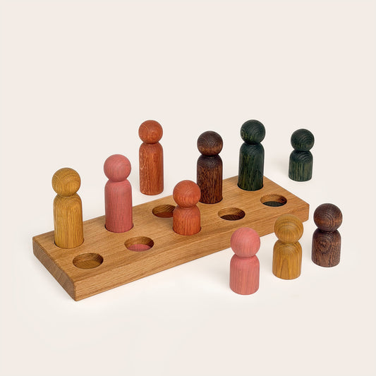 Play & Hang in Natural Oak with Earth Palette, a wooden sorting toy with colour-matching pegs that transforms into a children's coat rack by Woodsie Wonder.
