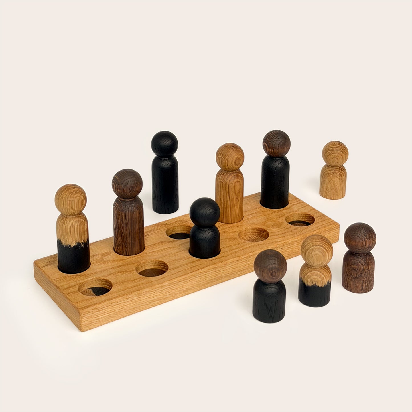 Play & Hang in Natural Oak with Mono Palette, a wooden sorting toy with colour-matching pegs that transforms into a children's coat rack by Woodsie Wonder.